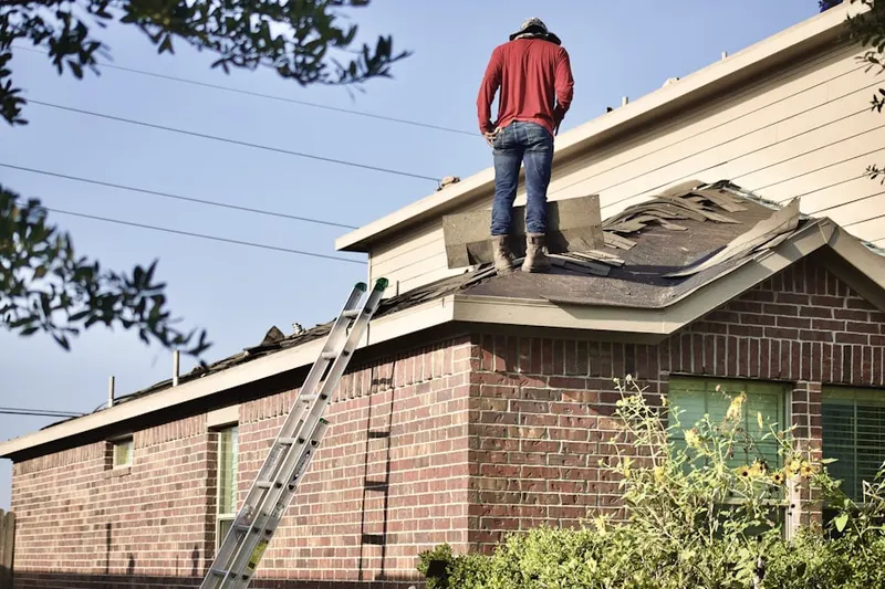 Professional roofer working on a residential roof in Edgewater Beach